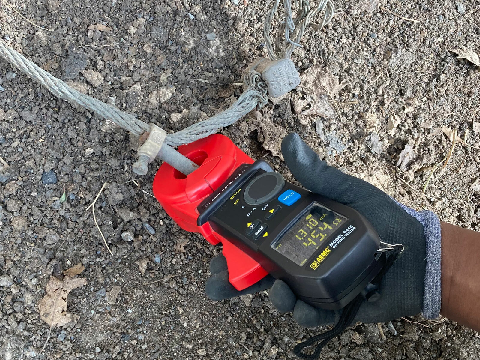Ground resistance meter, with a high reading, being used to test a ground rod