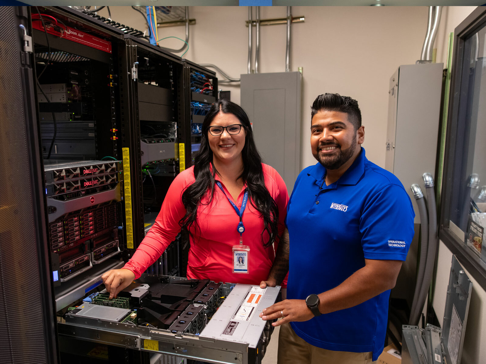 Two technology specialists working on a virtual server.