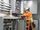 An employee works with wires in an electrical box.