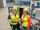 Two employees in PPE gear with networking monitoring equipment.