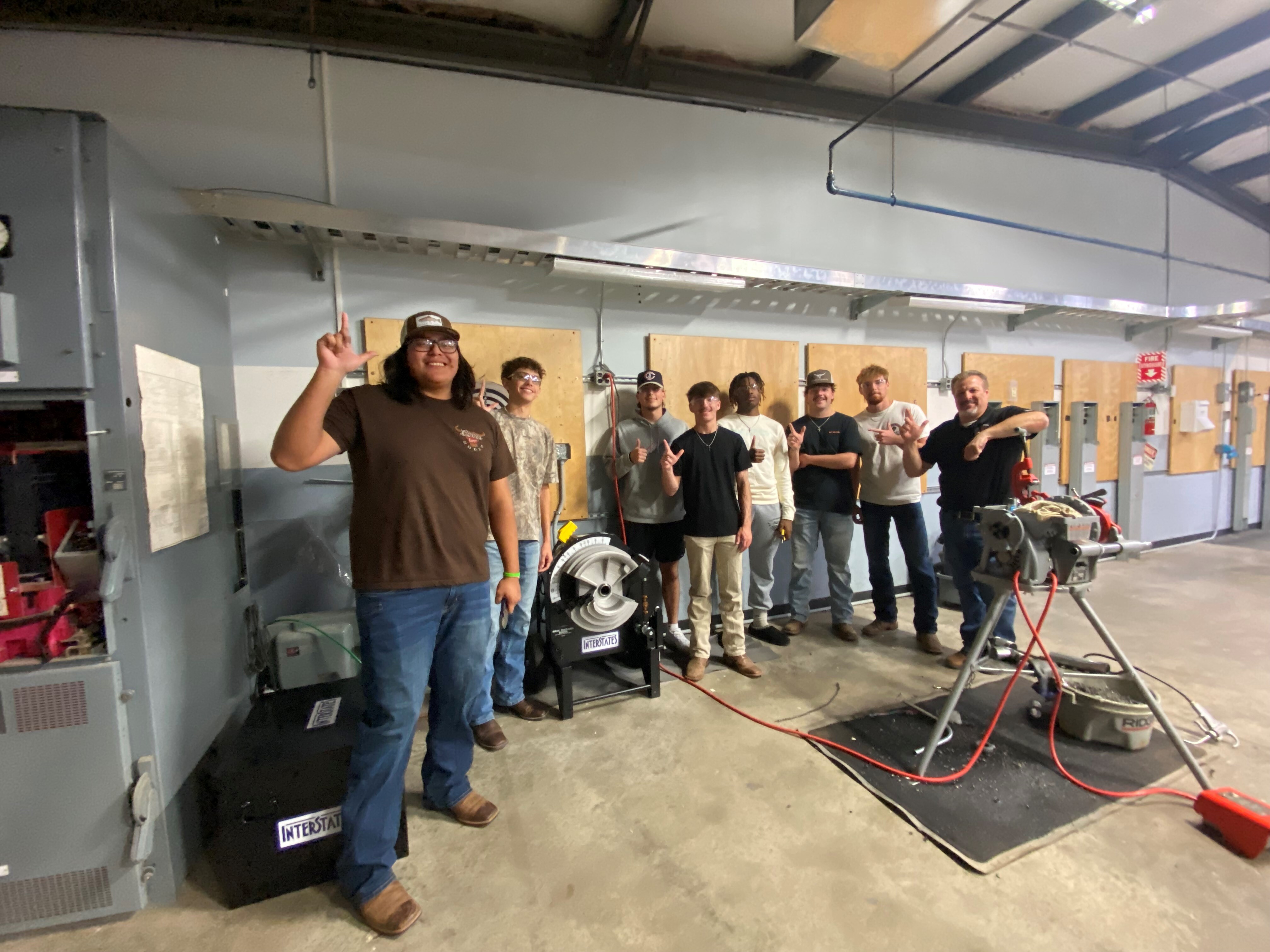 group of students from OSUIT standing next to a conduit bender