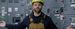 man with yellow hardhat with arms stretched outwards