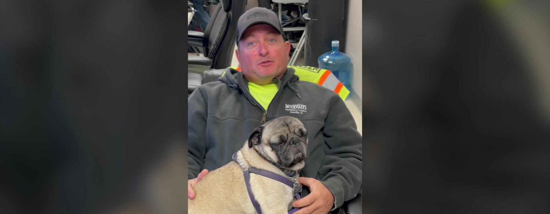 man sitting in a chair with a dog on his lap