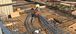 Two men bending conduit at a construction site.