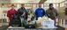 Five people with backpacks, tool kits, and other things to donate to future electricians.