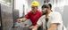 Two men collaborating around computer monitors.