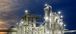 Image of an ethanol plant at night with the lights on.