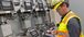 man in yellow ppe gear working on an iPad