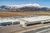 Outside view of a food processing facility with mountains in the landscape.