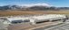 Outside view of a food processing facility with mountains in the landscape.