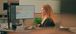 Woman viewing data on computer monitors.