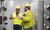 two men in PPE observing in an electric room