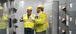 two men in PPE observing in an electric room
