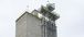 external view of the top half of the feed mill with a cloudy sky in the background