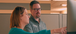 Two colleagues in an office collaborate at a computer. The woman points at the screen while the man, wearing an Interstates polo, listens attentively.