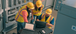 Three Team Members Working On Laptop