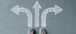 A pair of shoes standing at the base of three arrows pointing in different directions.
