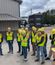 A group of people outside in construction gear.