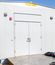 Two completed modular electrical buildings outdoors with double access doors, exterior ventilation equipment, and coiled electrical cables in the foreground.