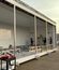 Modular electrical building under construction with an open side, exposed structural framing, and workers assembling components inside.