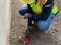 Employee Looking at Equipment on Ground