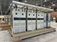 Large electrical equipment skid with multiple Allen-Bradley drive cabinets, electrical enclosures, power cables, and overhead cable tray inside a manufacturing facility.