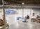 inside a partially empty warehouse with a forklift and stacks of product
