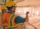 Two people in hard hats overlooking industrial facility operations from the second level of a plant