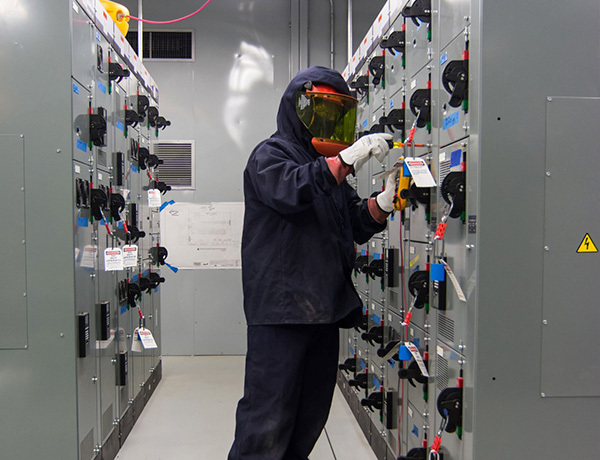 An electrician looks for potential hazards.