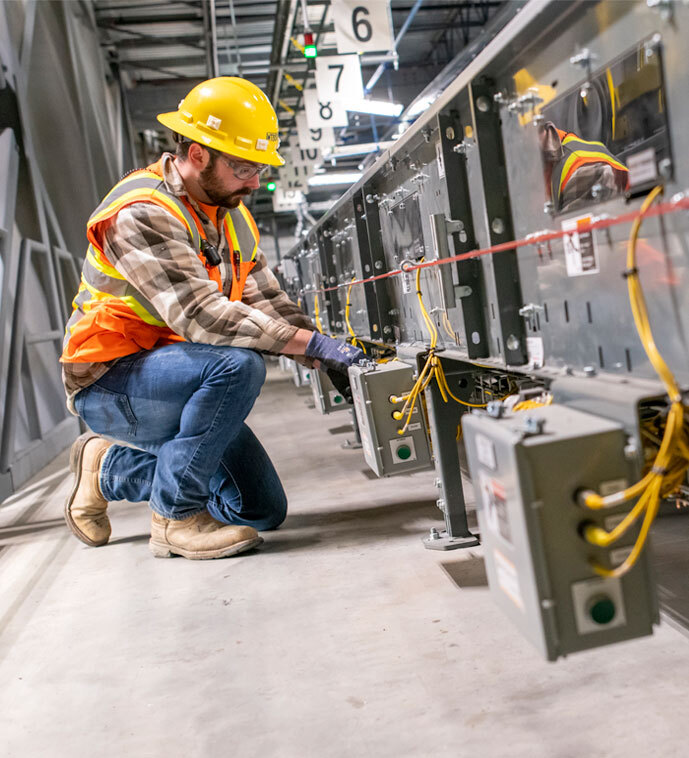 Electrician pulling wire in an industrial facility