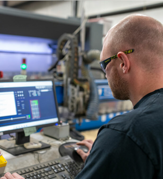 Employee running a skid in the prefabrication shop.