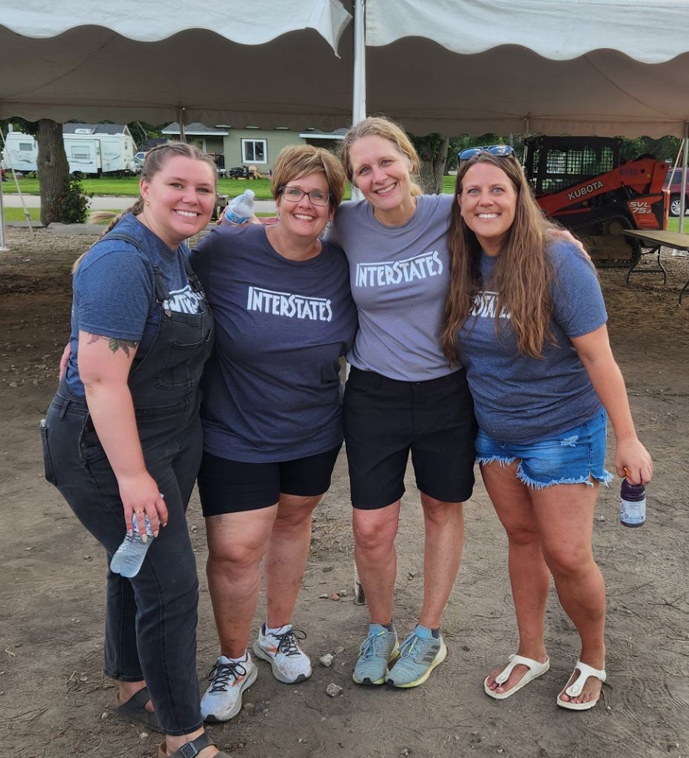 Four female team members smiling