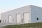 Outside view of a white building surrounded by grass for a water/wastewater treatment plant.