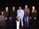 a group of people on a stage accepting an award