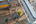Overhead view of a worker in high-visibility safety gear operating equipment within a scaffolded industrial work area.